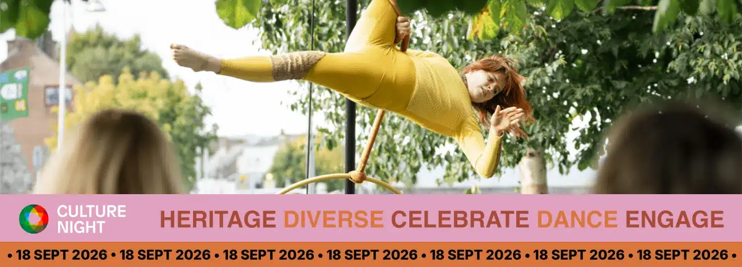 A performer in a yellow outfit balances on an aerial hoop outdoors, watched by two people, with trees and buildings in the background. Text promotes Culture Night on 18 September 2026 with themes of heritage and diversity.