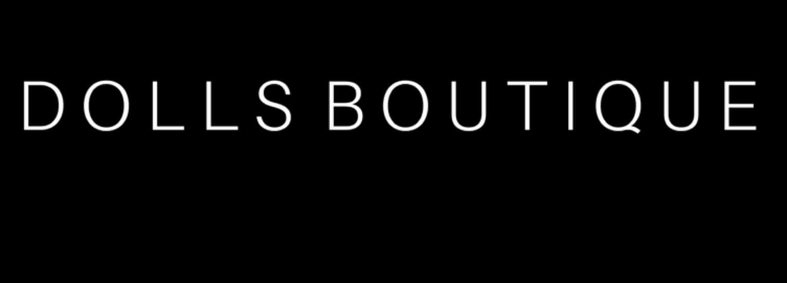 White text on a black background reads "DOLLS BOUTIQUE" in uppercase, thin sans-serif font.