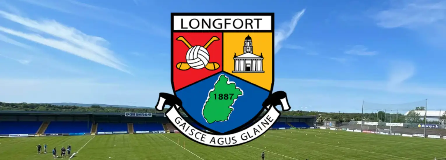 The Longford GAA crest is displayed over a Gaelic football stadium with a green pitch, blue seats, and clear skies in the background. The crest features symbols, the year 1887, and the motto "Gaisce Agus Glaine.